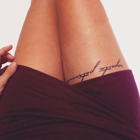 Script tattoo on thigh